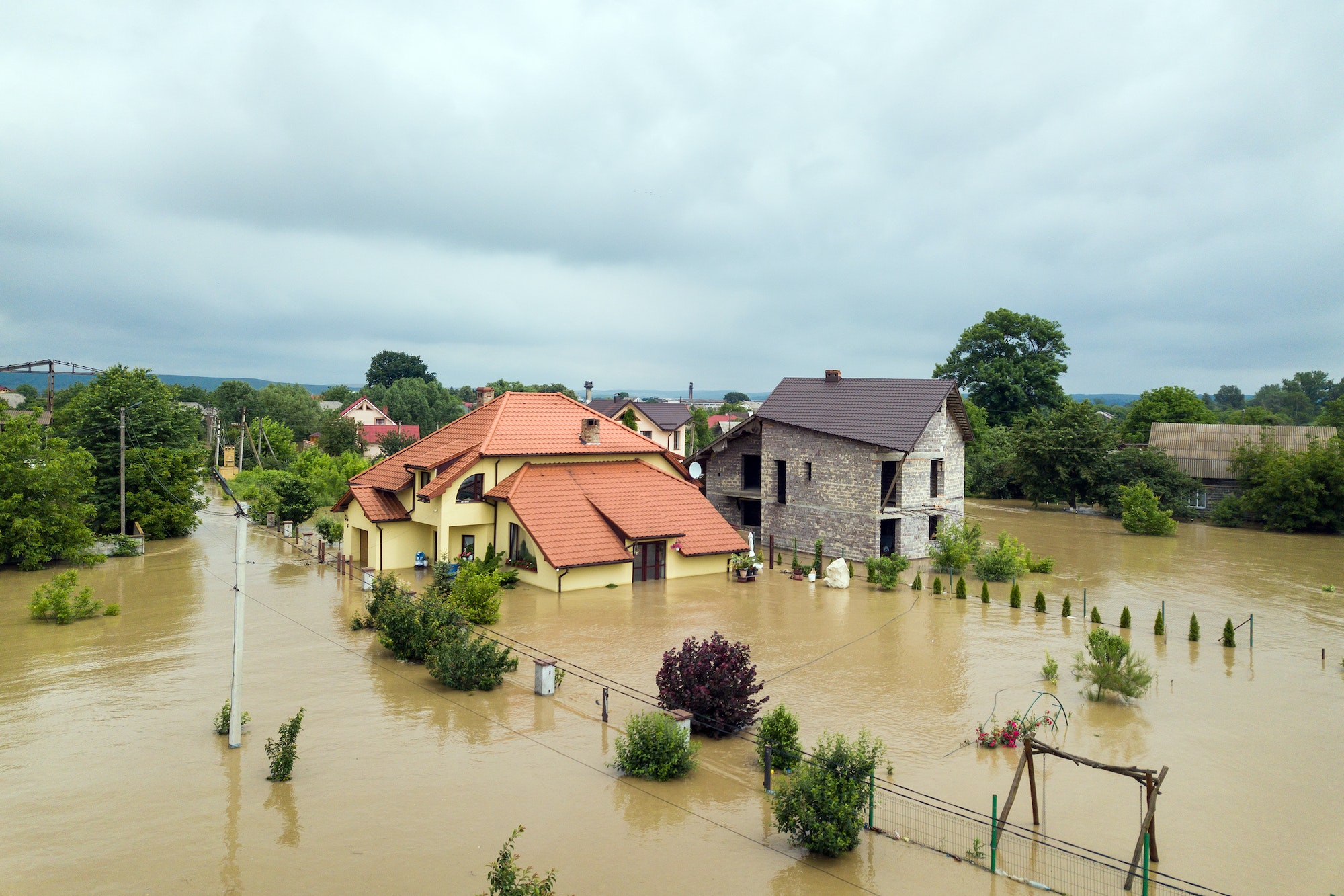 Aerial view of flooded houses with dirty water of Dnister river in Halych town, western Ukraine