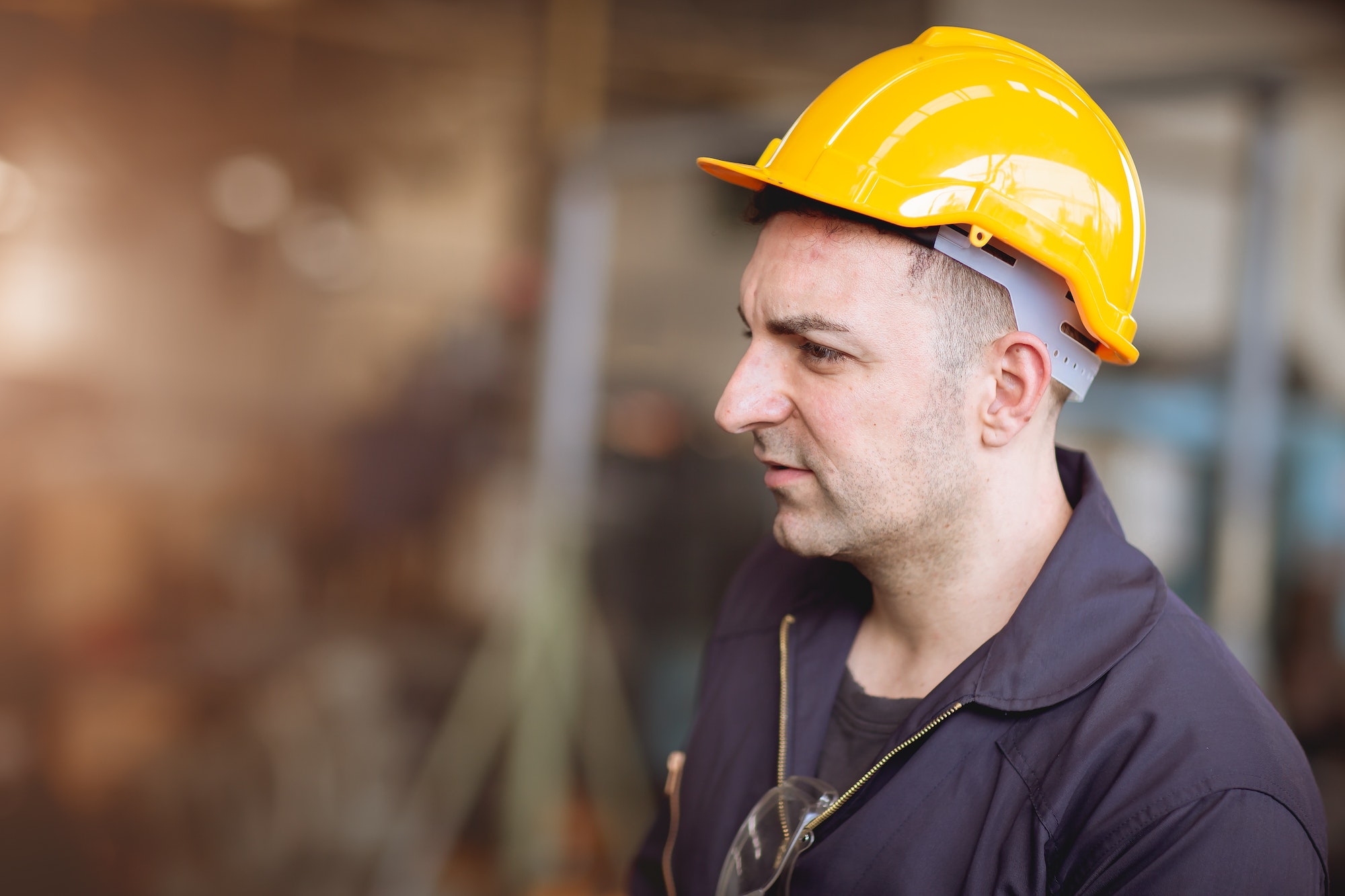 European Russian worker profile image handsome gentleman look wearing helmet safety suit work in fac